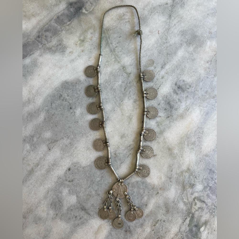 Silver coin necklace on thin rope